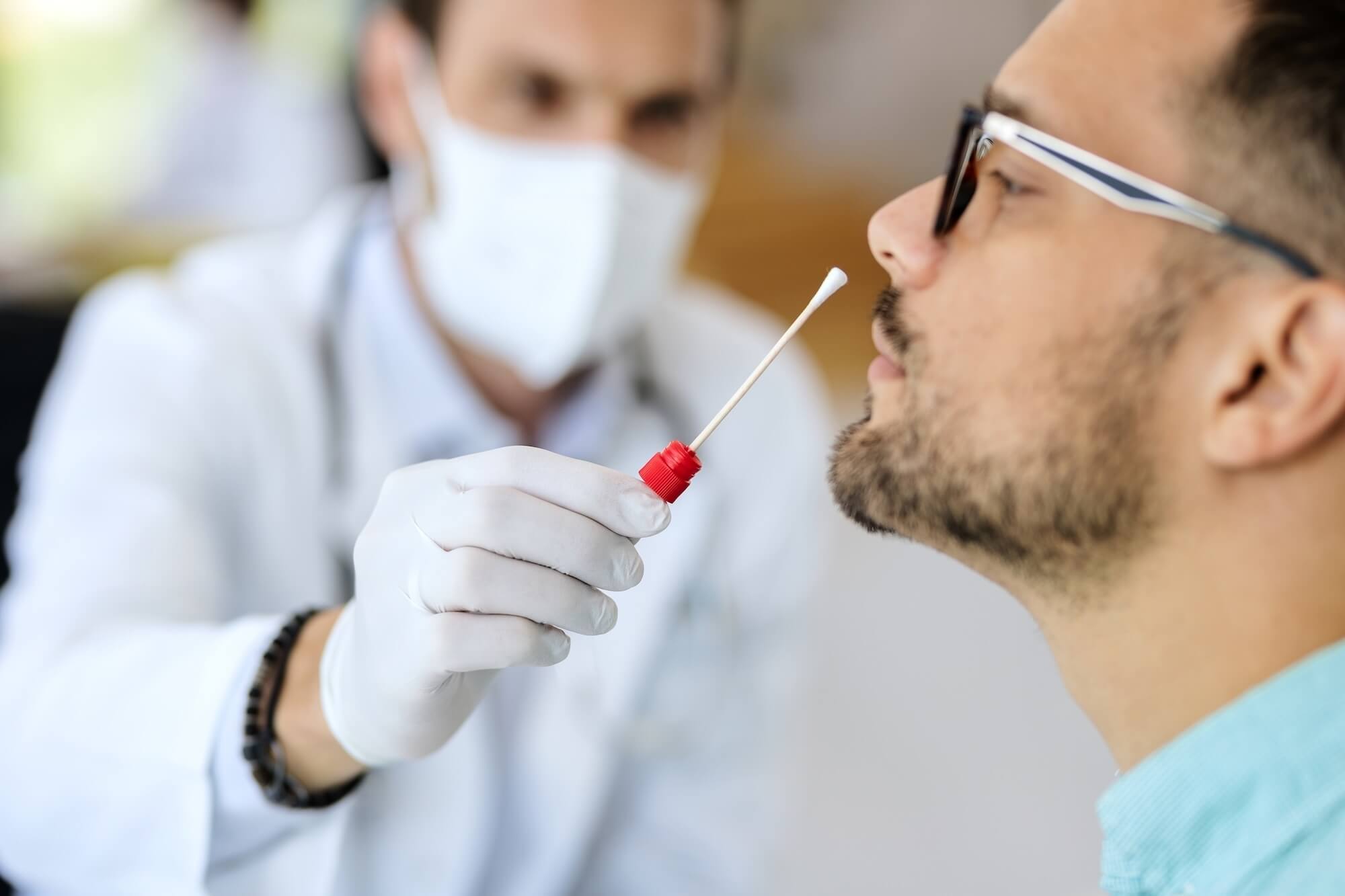 Man receiving PCR test in clinic.